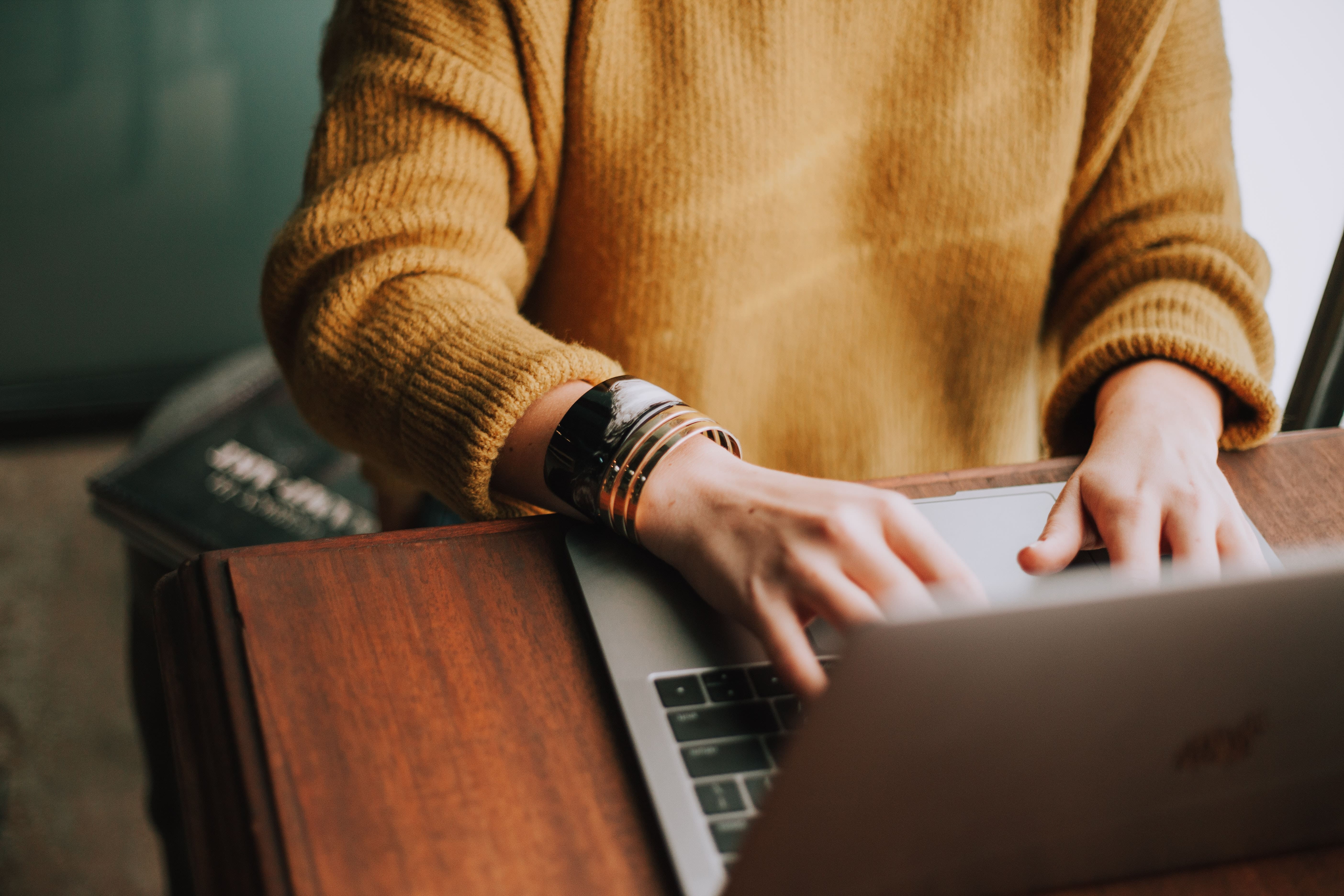 woman writing on a computer