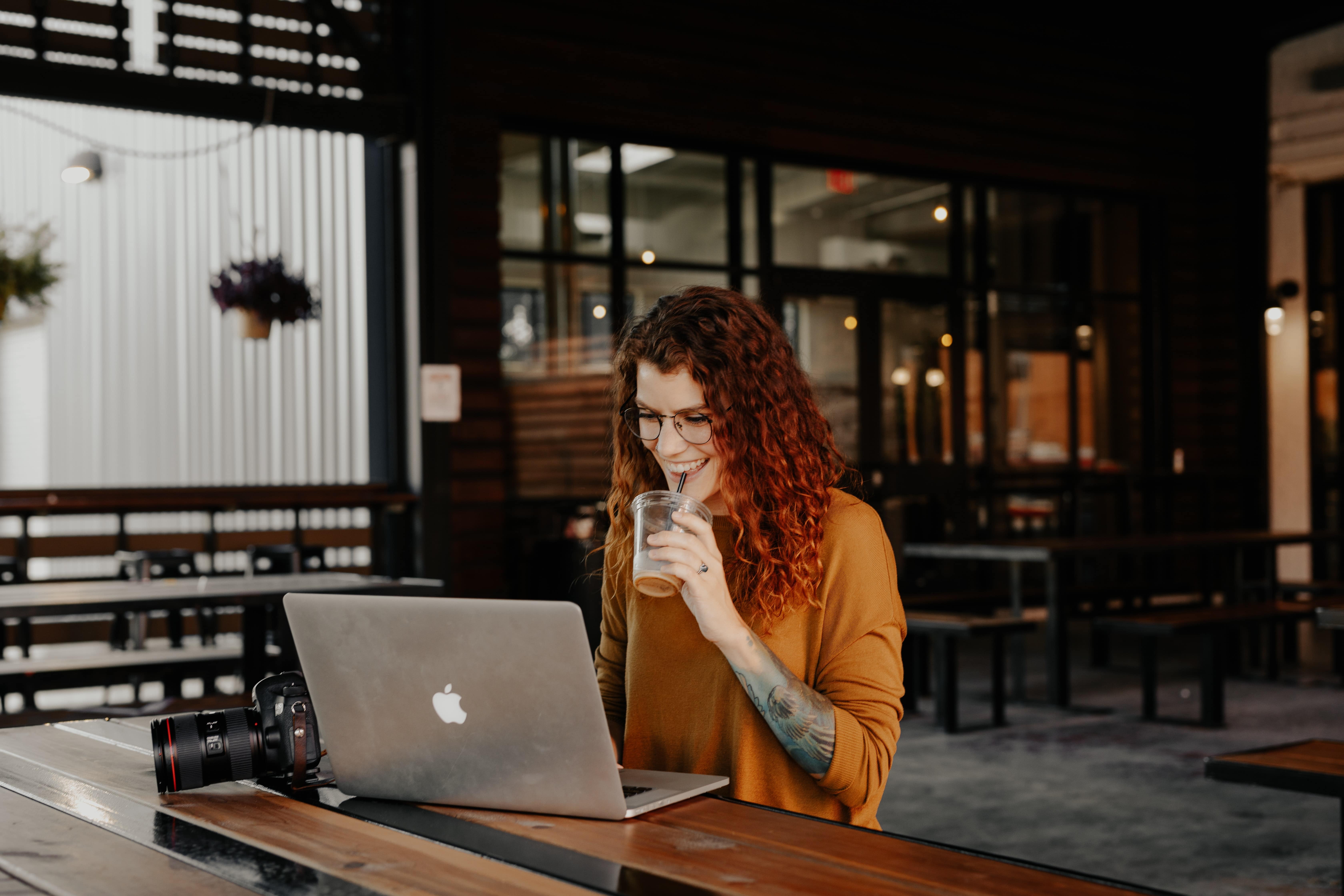 woman sitting on coffee with a computer